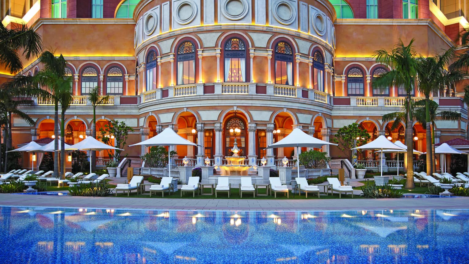 The crystalline pool in front of the decadent building