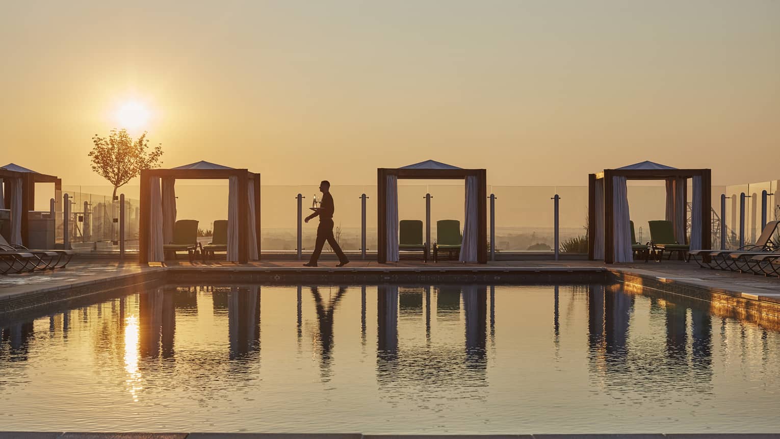 Poolside cabanas during sunset.