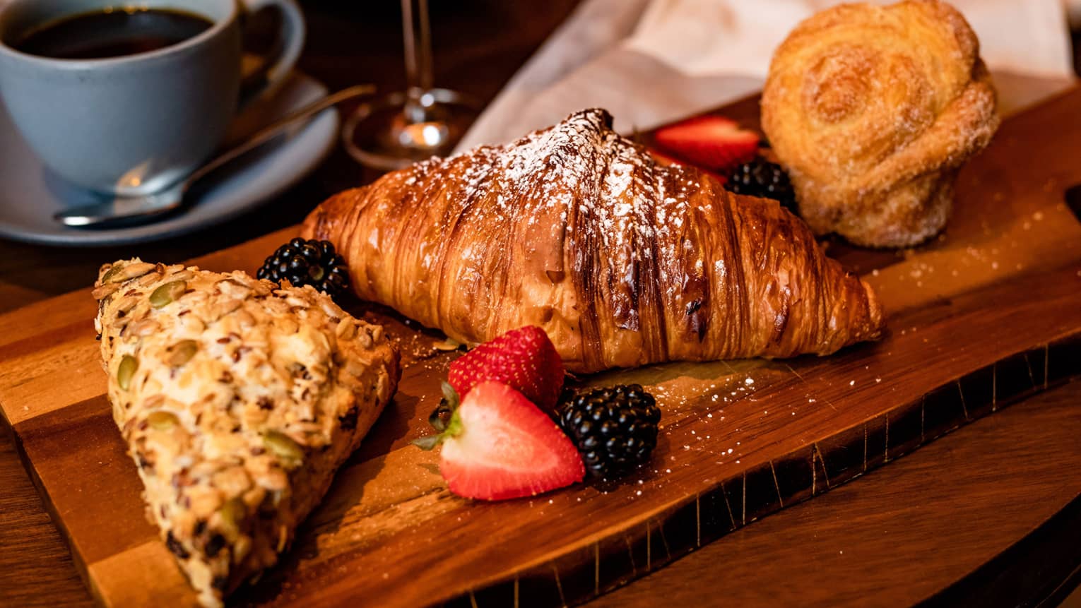 An assortment of pastries including scones and croissants.