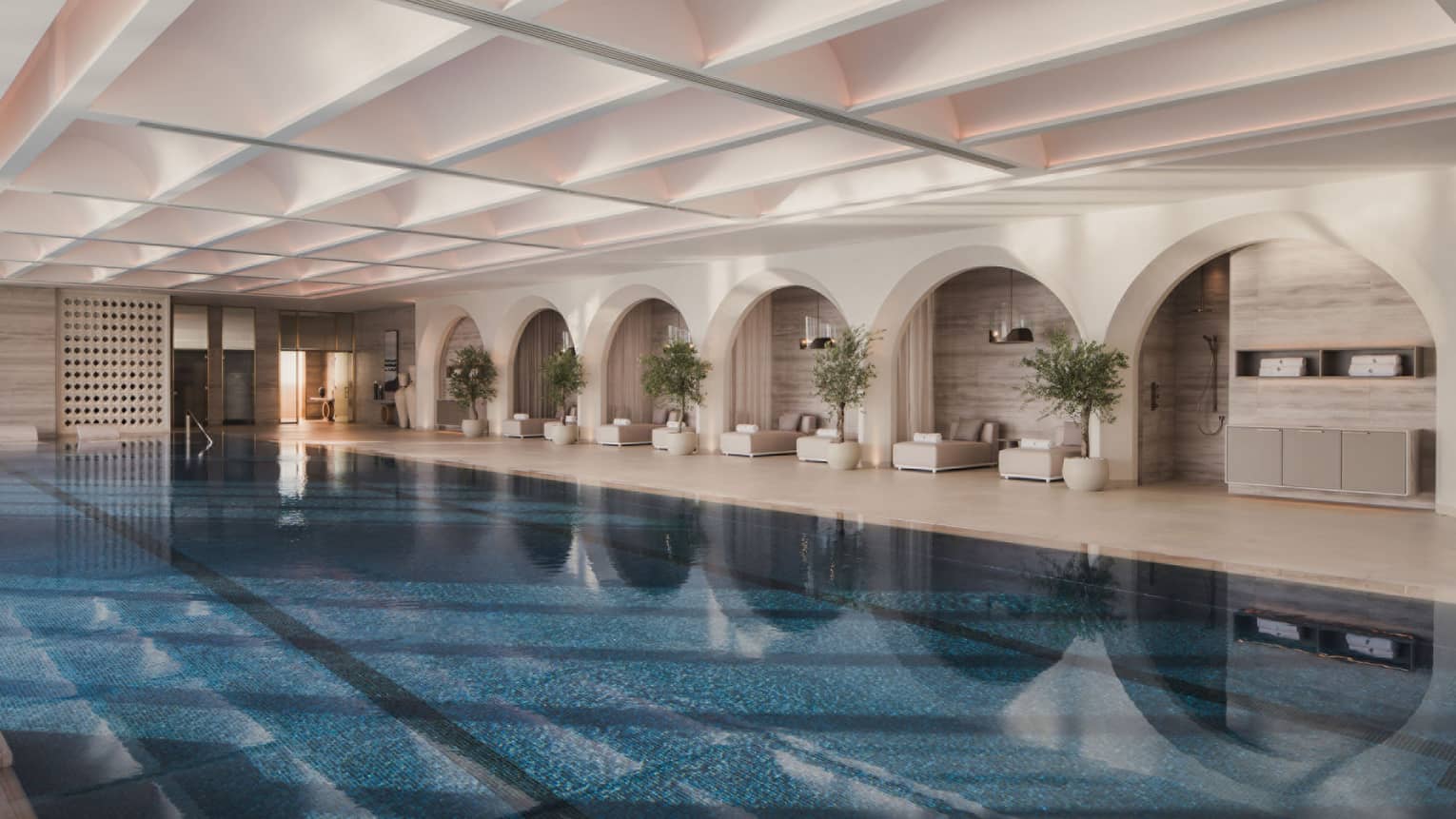 Large indoor swimming pool with pool lounge chairs