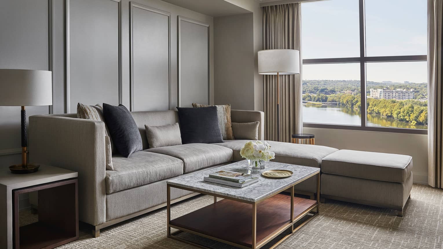 Lake View Suite grey sectional sofa, cushions by floor lamp, large window