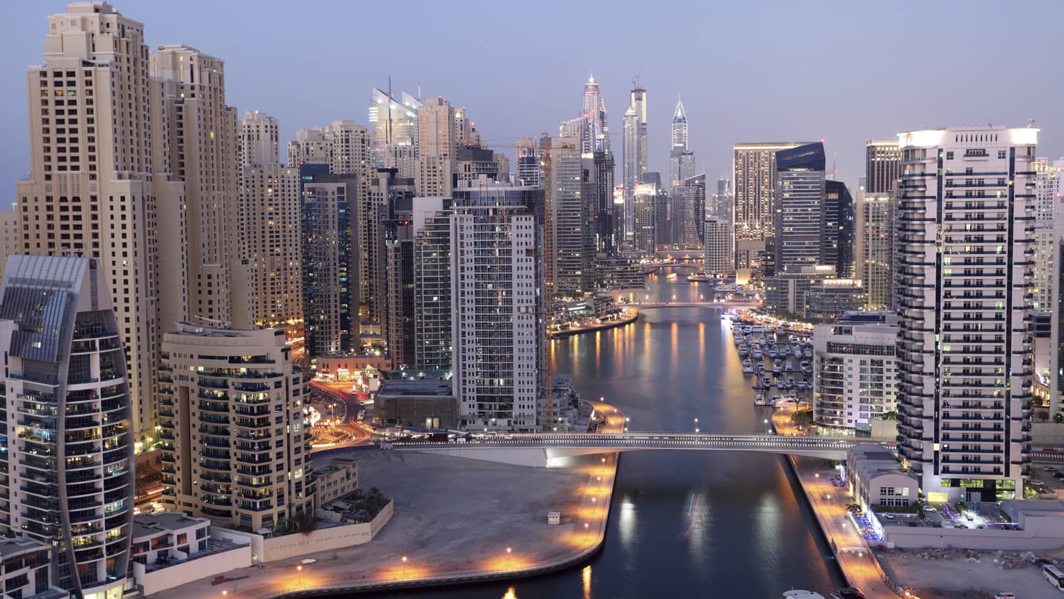 Dubai skyline buildings and marina at dusk