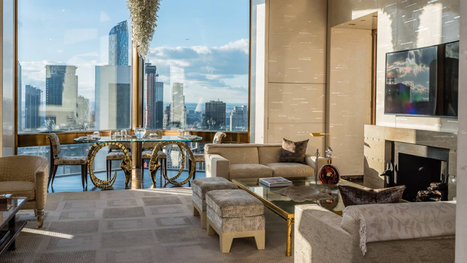 Bright Ty Warner Penthouse with modern gold dining table, chandelier by floor-to-ceiling window