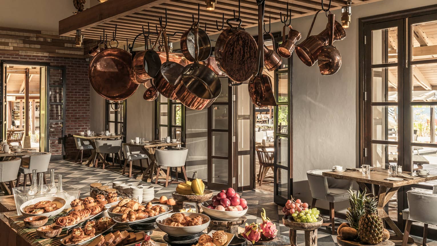 Claudine restaurant interior with hanging copper pots over buffet