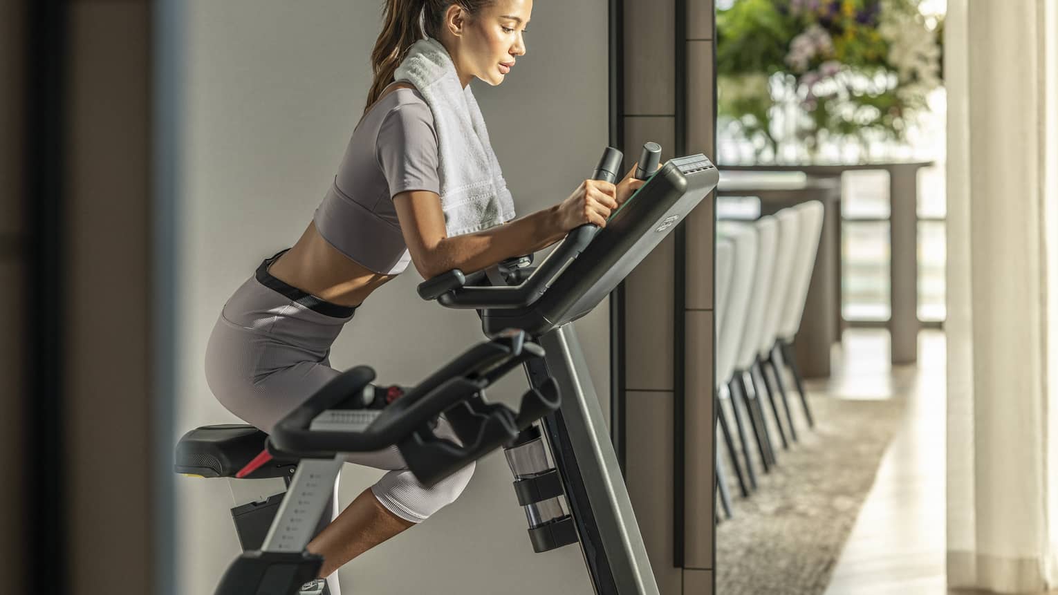 Woman rides Peloton in Presidential Suite