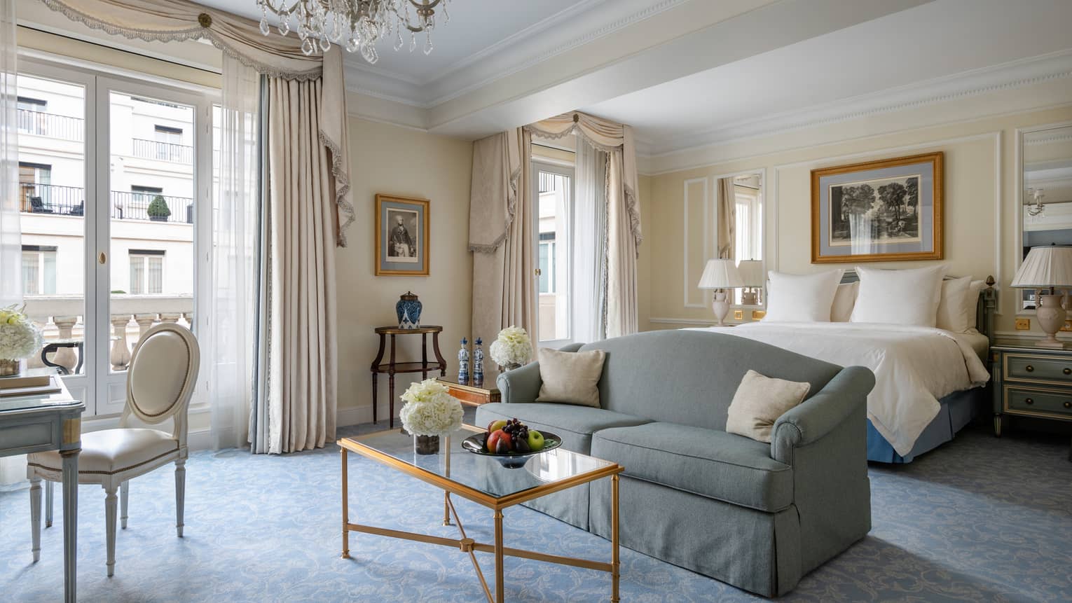 Premier room with queen bed, couch, coffee table, cream & teal Victorian accents, natural light 