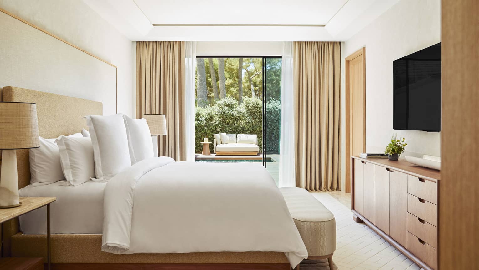 Contemporary suite with king bed and walk-out garden-view terrace at Four Seasons Resort Mallorca