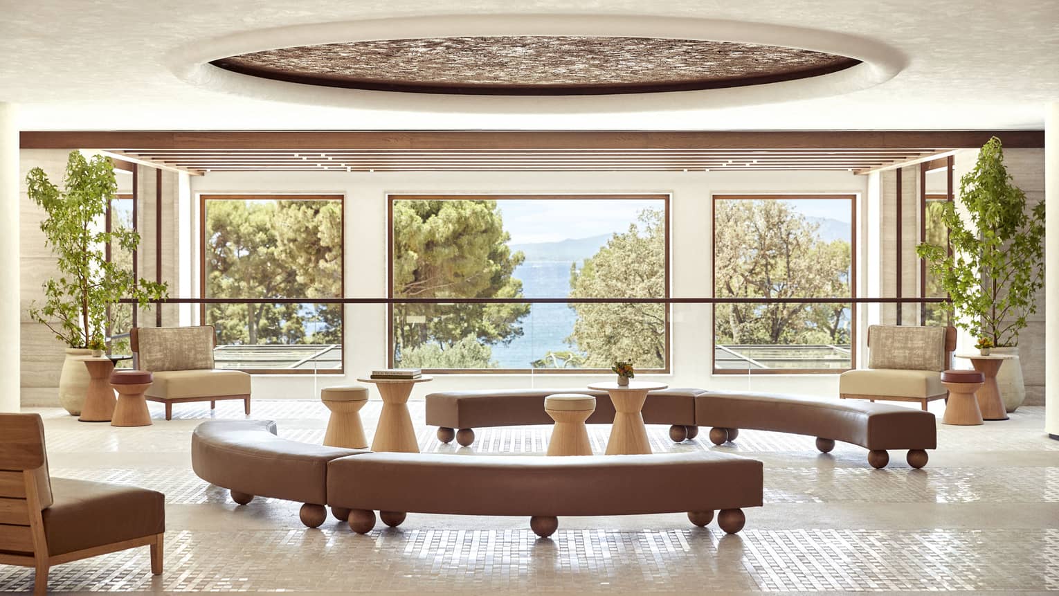 Four Seasons Resort Mallorca lobby with three picture windows looking out to pine trees and sea