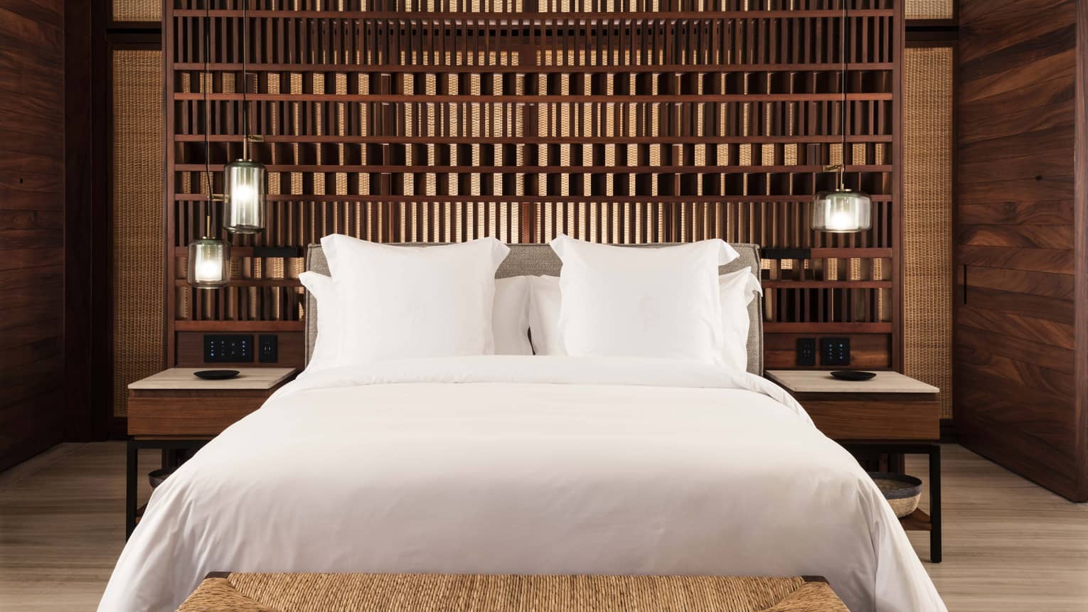 King bed in front of geometric wooden accent wall
