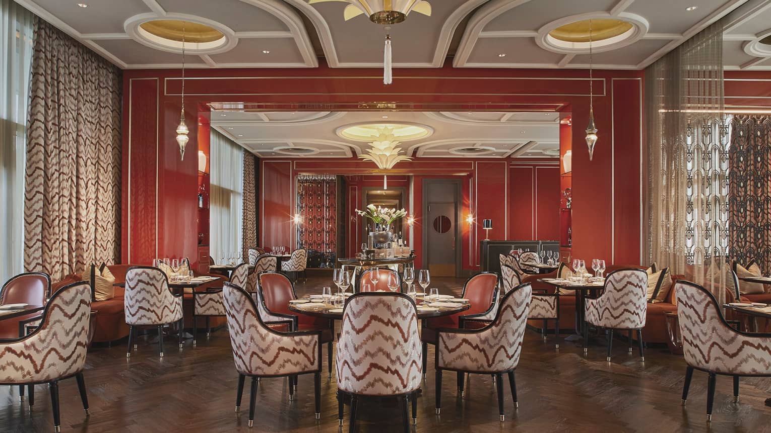 Alto restaurant dining room, each round table has four arm chairs, stylish geometric paterns