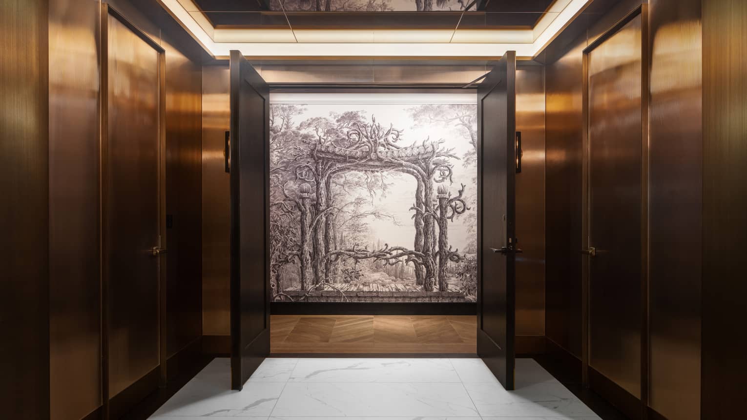 Interior wood-panelled hallway with two doors opening up to reveal a black-and-white painting