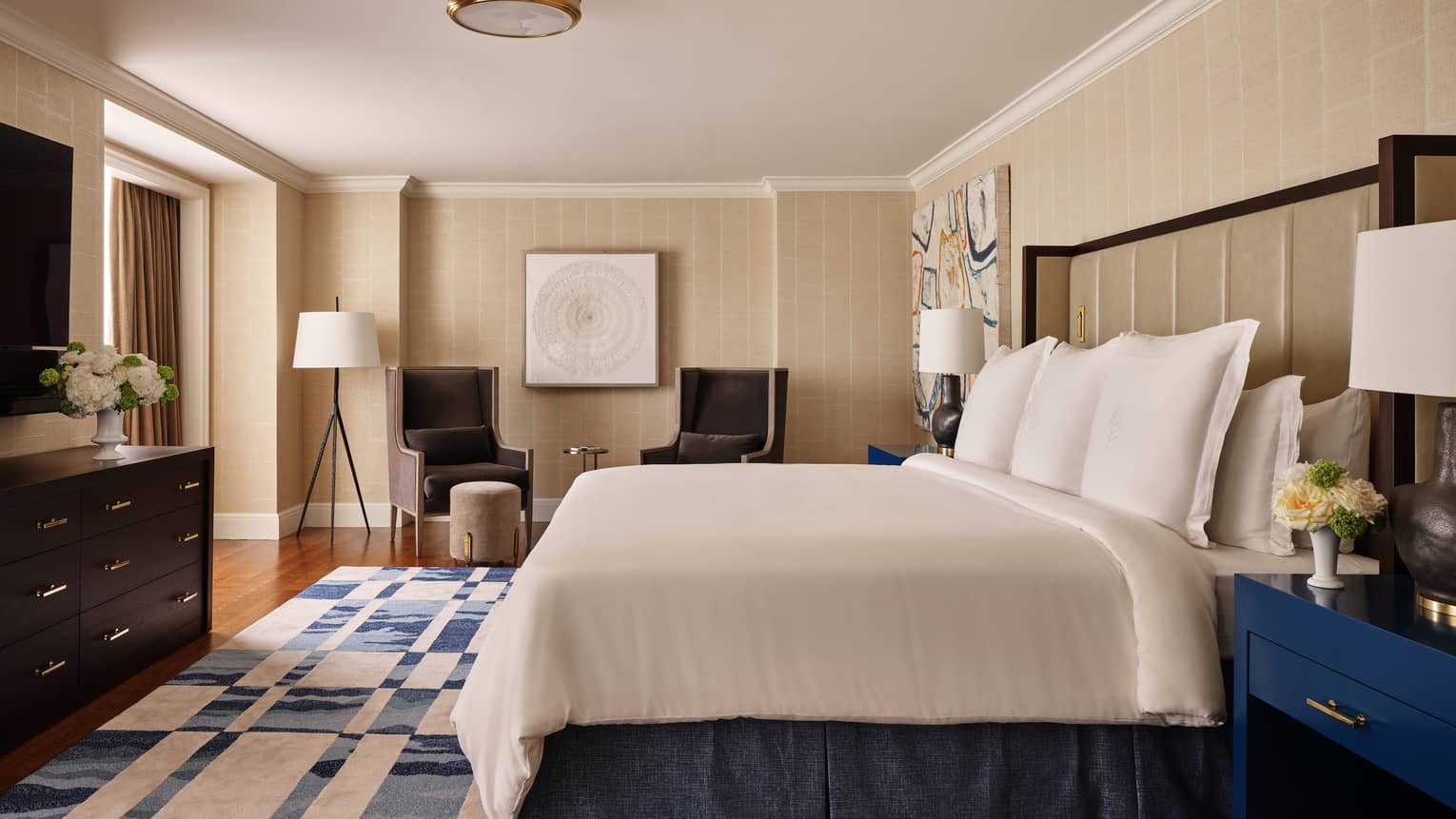 Contemporary luxury bedroom with king bed and blue-and-white area rug