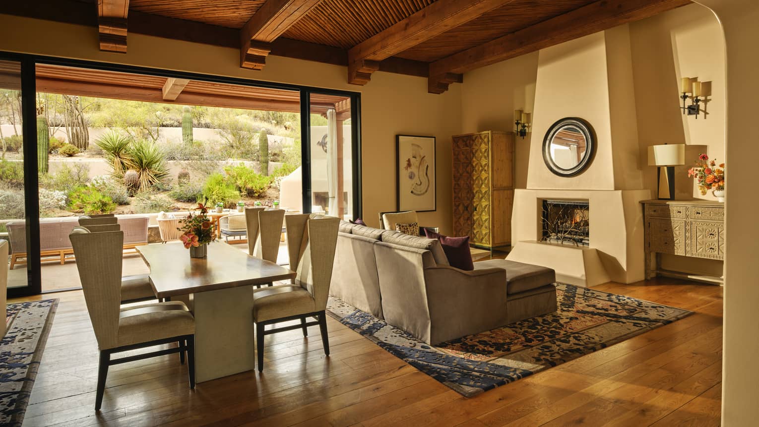 Luxury resort suite with Southwestern design, fireplace, hardwood floors, sofa and dining table