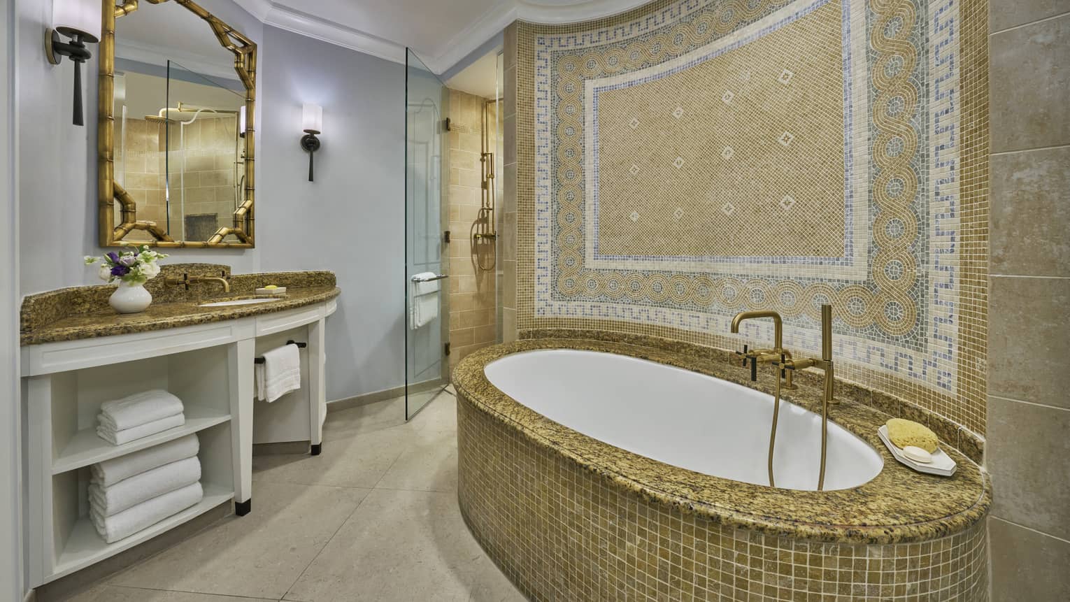 Luxury bathroom with a mosaic-tiled bathtub, ornate wall design, large mirror, vanity and glass-enclosed shower area