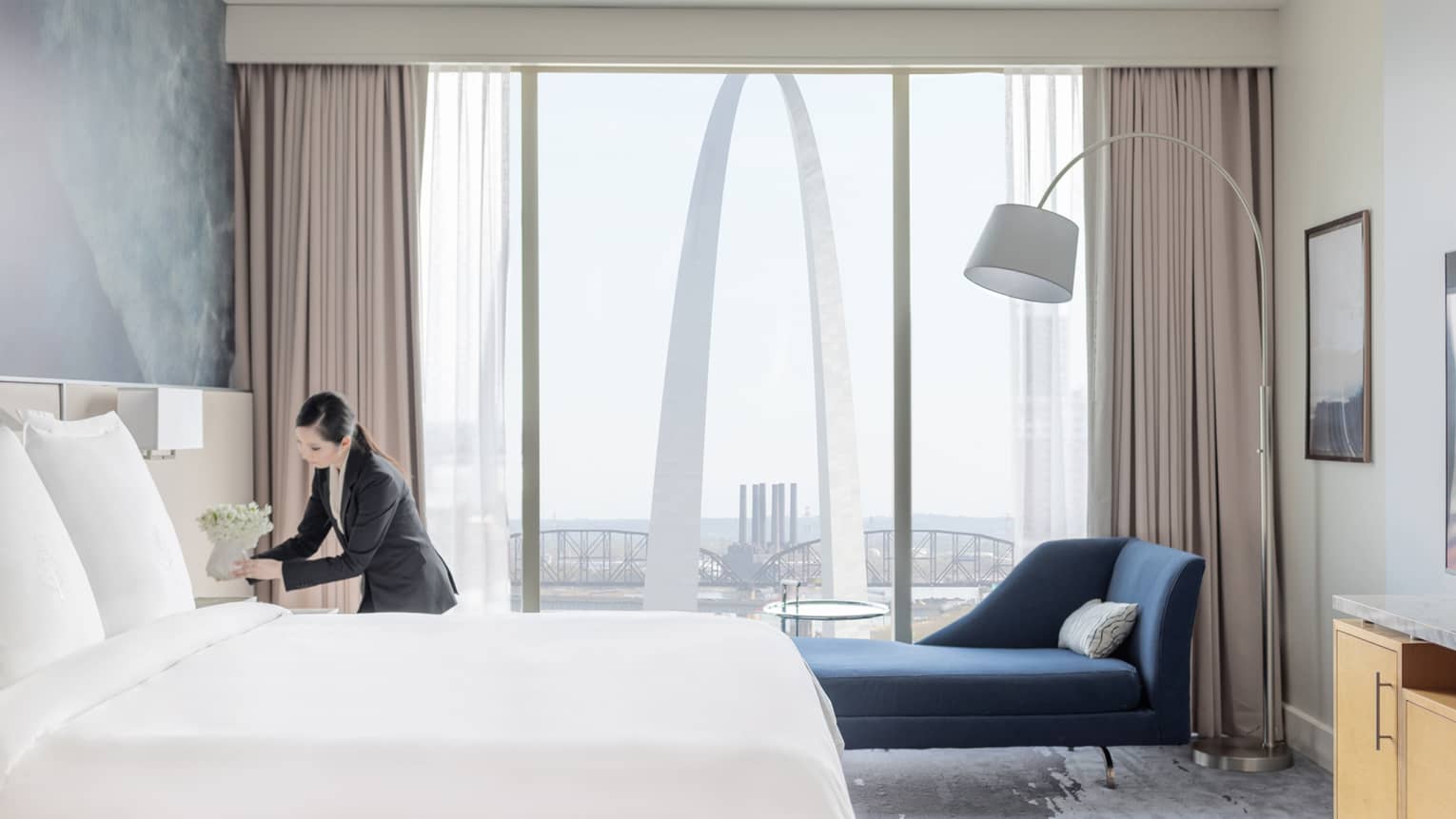 A hotel team member organizing a hotel room.