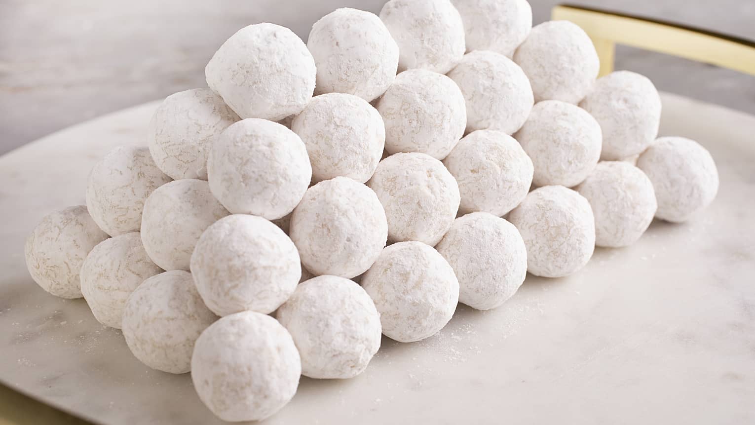 White marble platter stacked with White Chocolate Truffles