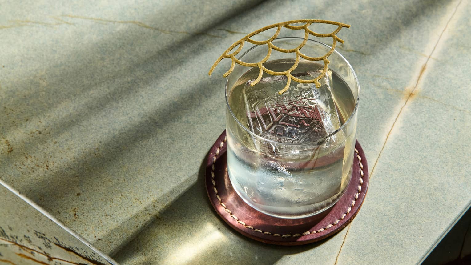 Cocktail in a rock glass with a lattice-style garnish