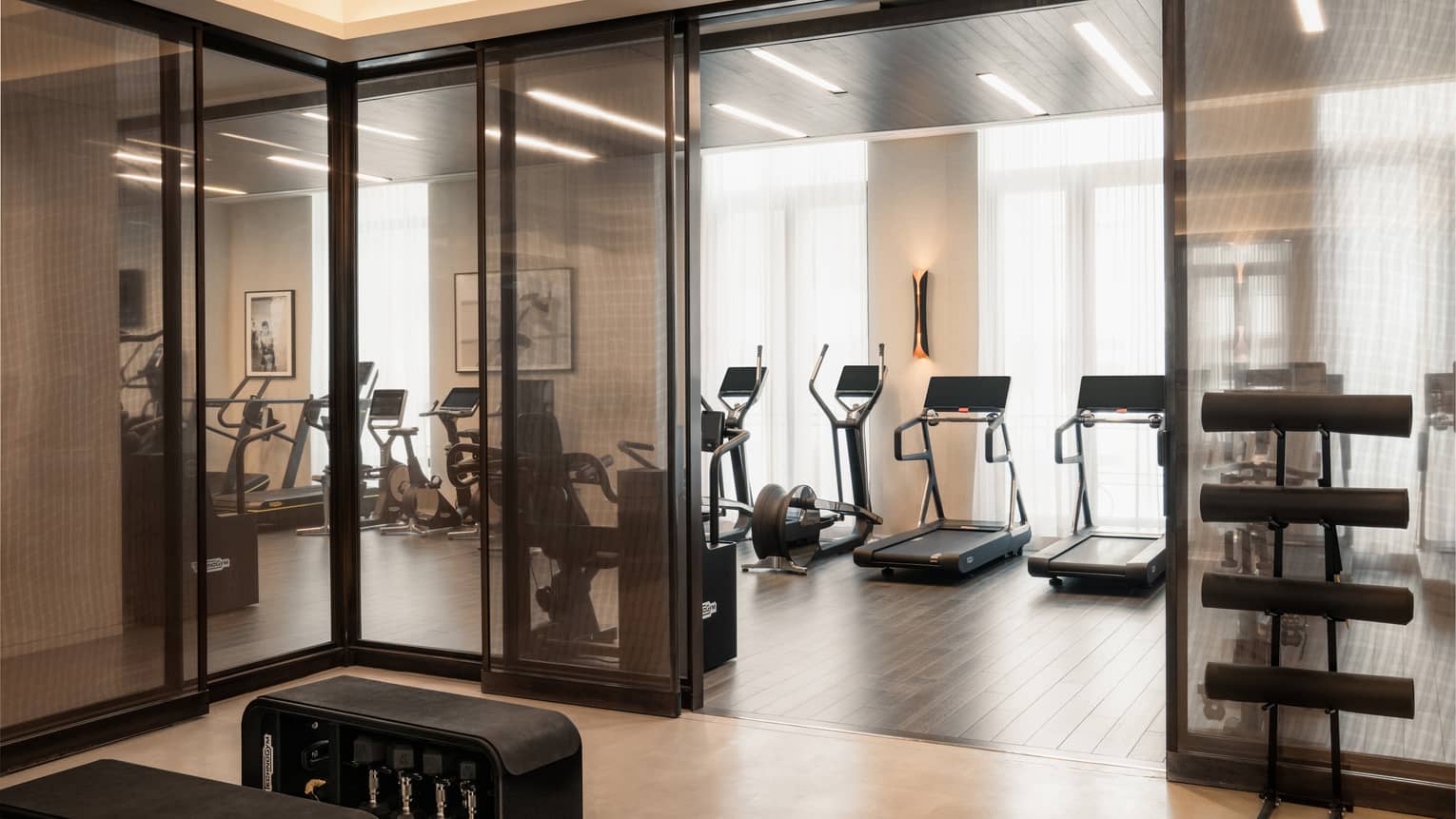 A Fitness Centre with exercise machines along the wall facing the windows