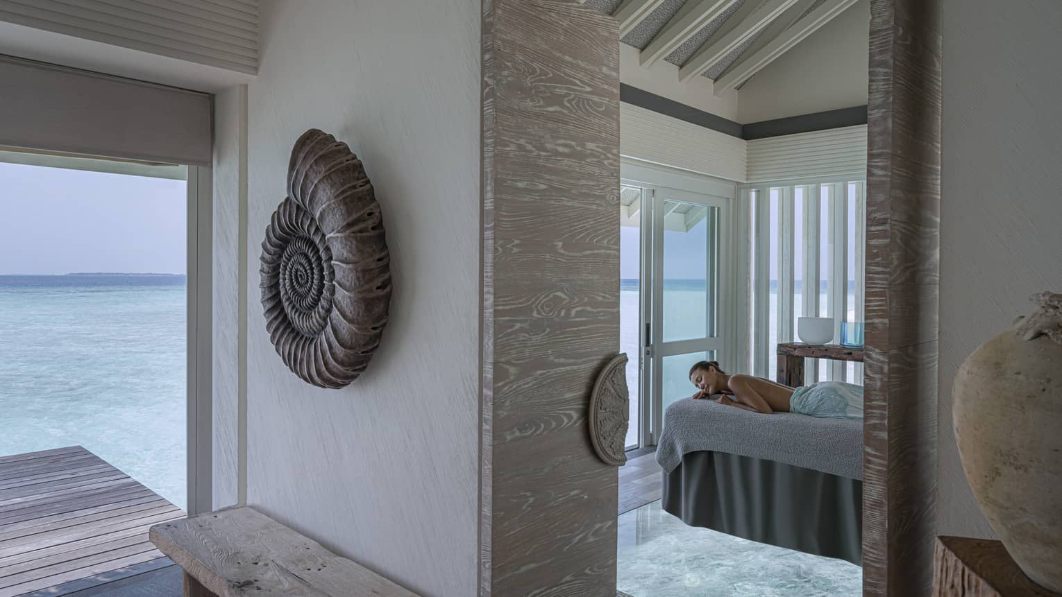 Woman on massage table overlooking the ocean at the Spa