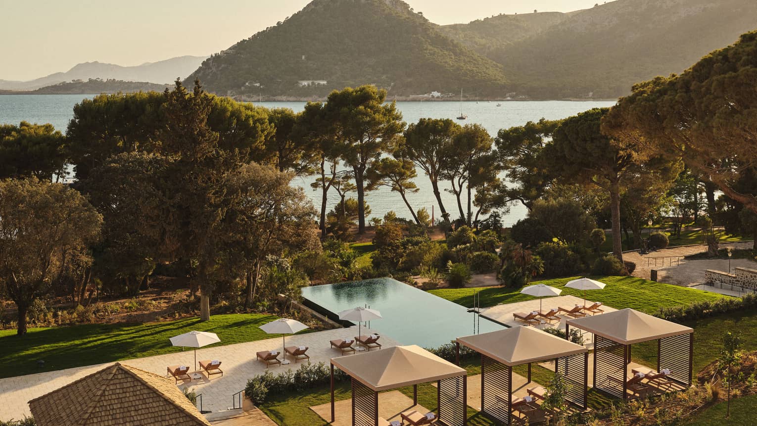 View of pool and ocean/mountain in background
