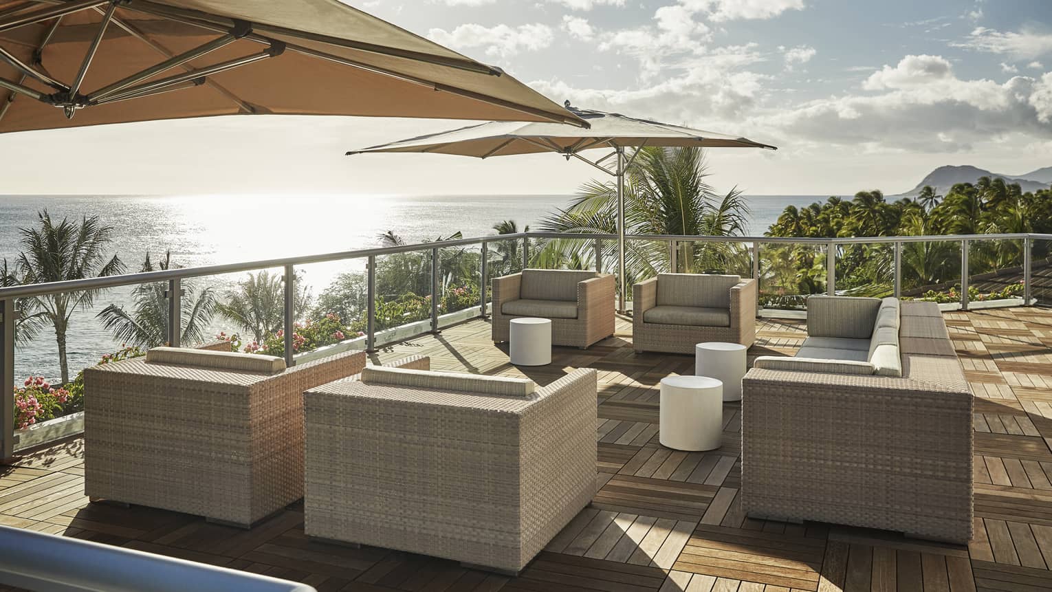 Presidential Suite patio with large wicker chairs, parquet floors, umbrellas, ocean view