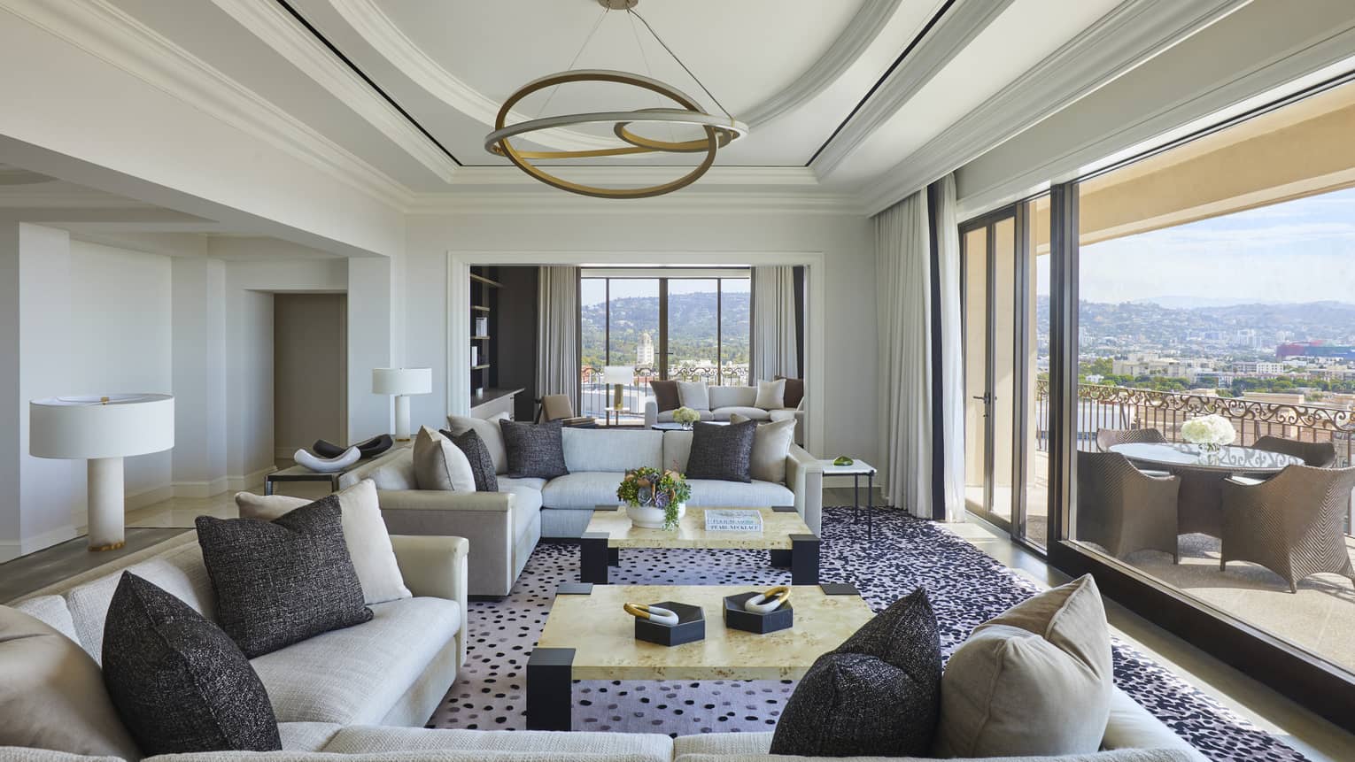 Large living room opening to city-view terrace