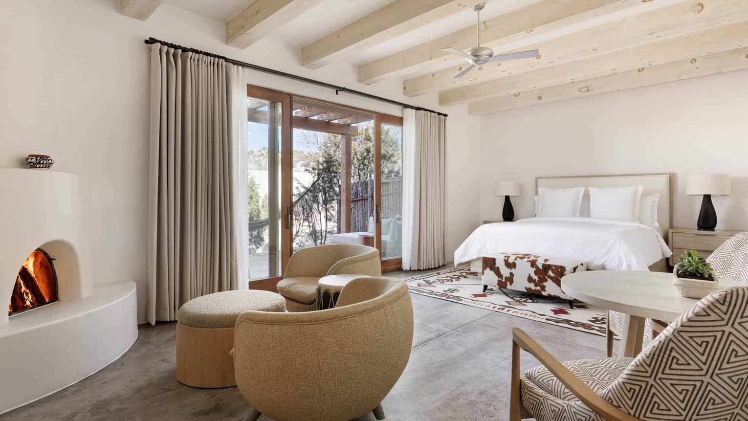 Premier guest room with sitting area, king bed and private terrace at Four Seasons Resort Santa Fe