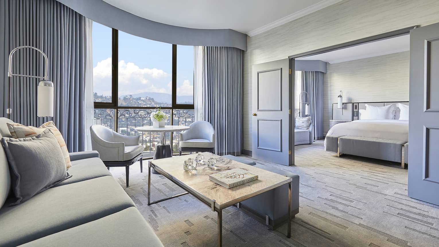 Hotel suite living room with sliding doors to bedroom