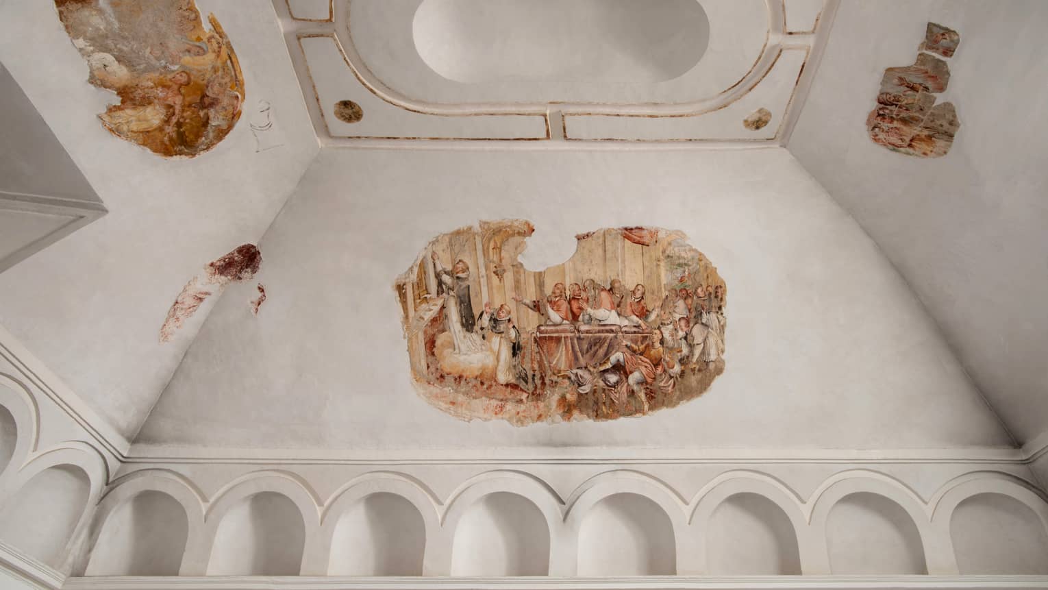 Frescos on white vaulted ceiling