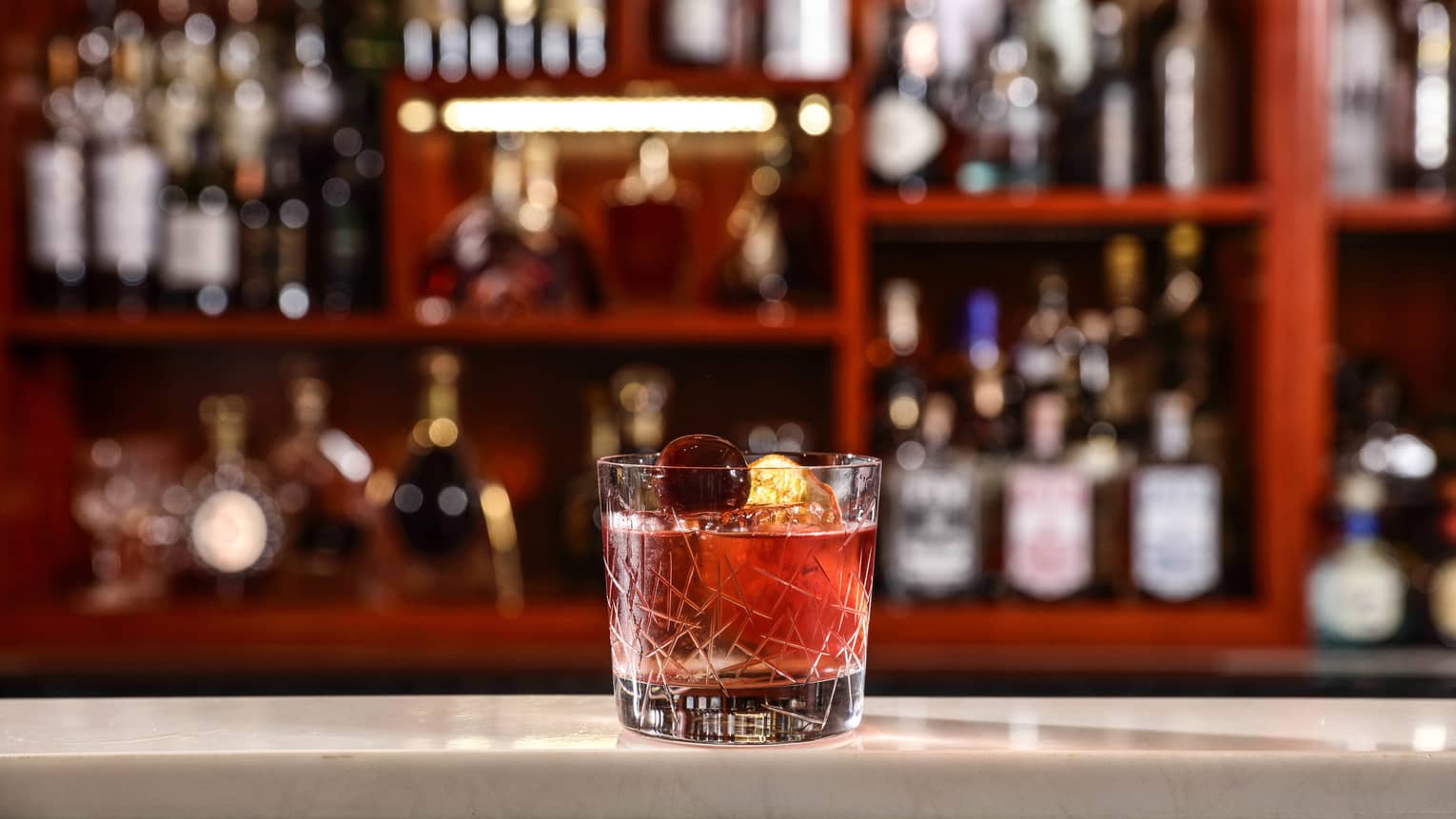 Old Fashioned cocktail in glass on bar 