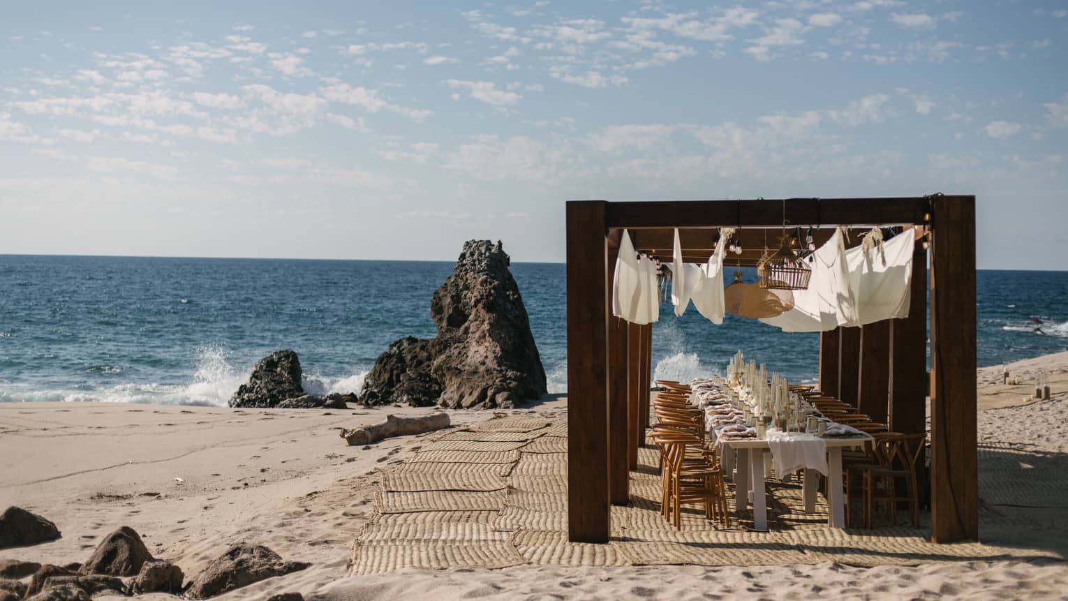 Group dining table setup on the beach