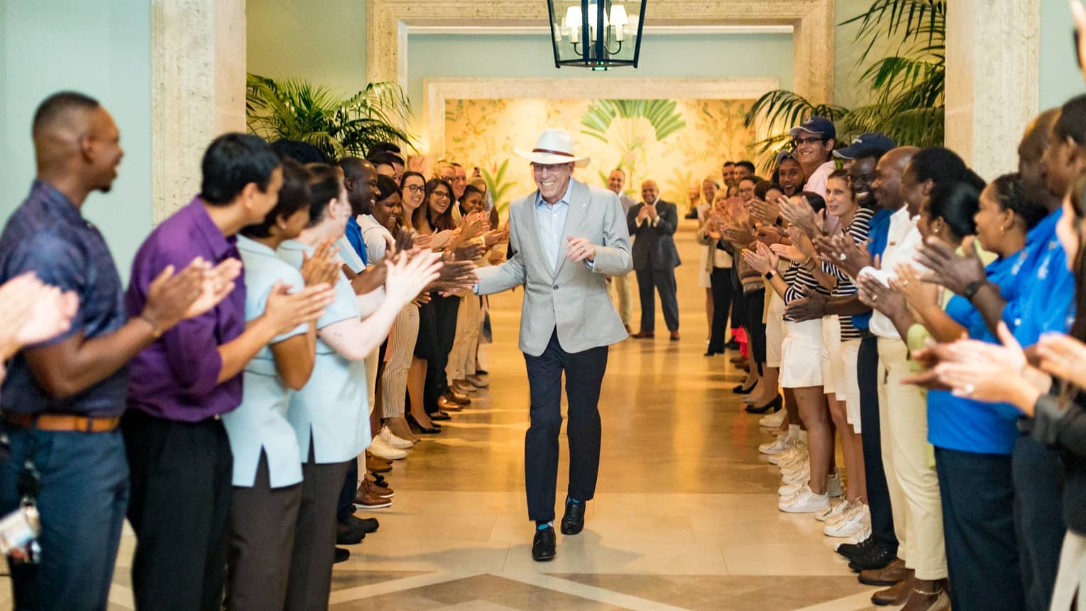 This image depicts Four Seasons founder, Isadore Sharpe, greeting staff at Four Seasons Resort Palm Beach, the home to many great ESG initiatives.