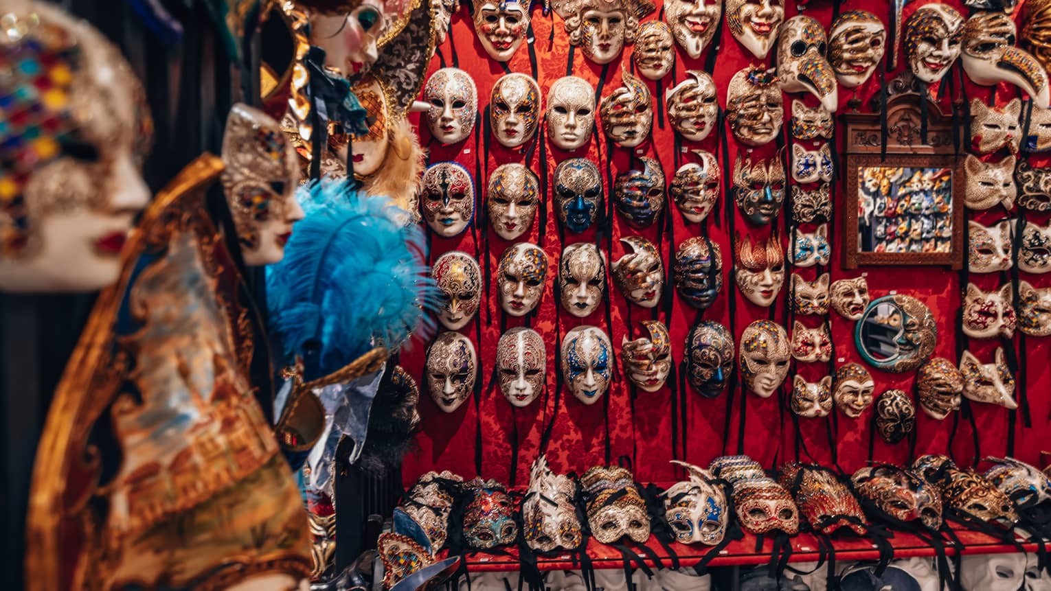 Venetian masks displayed on a wall