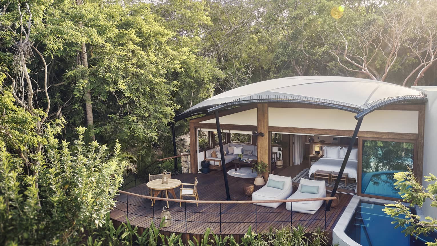Luxury tent with private plunge pool and deck surrounded by tropical forest
