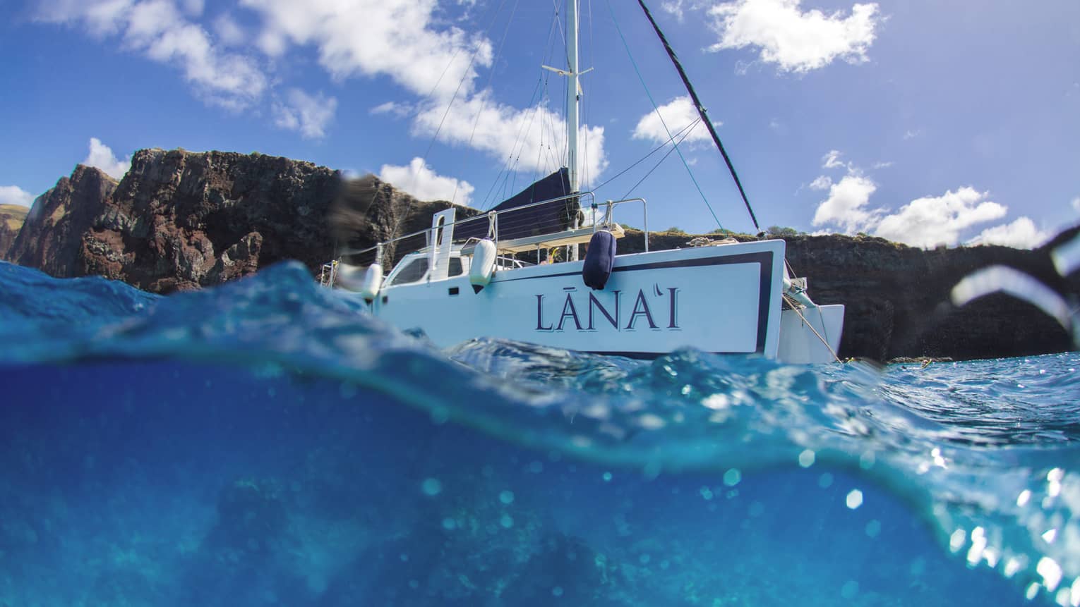 Lanai catamaran on blue waters headed out to sea