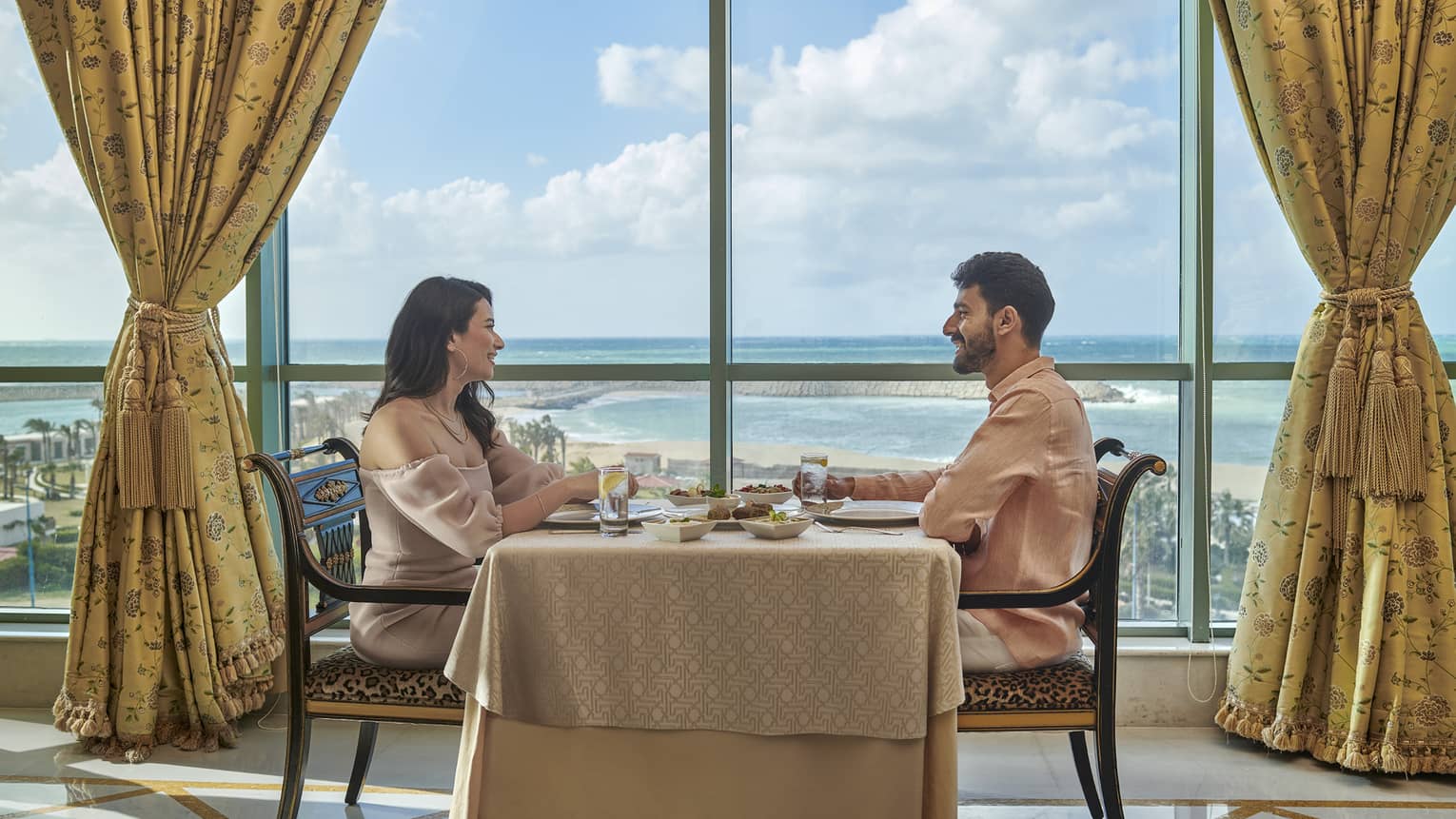 Couple enjoys a meal at Byblos Restaurant with views of the Mediterranean Sea