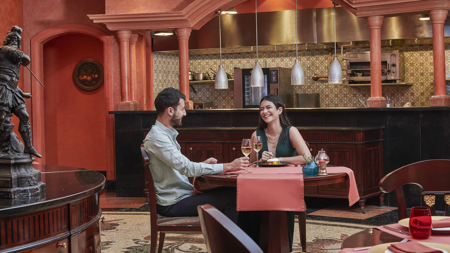 Couple enjoys a glass of wine at Stefano's, red accents