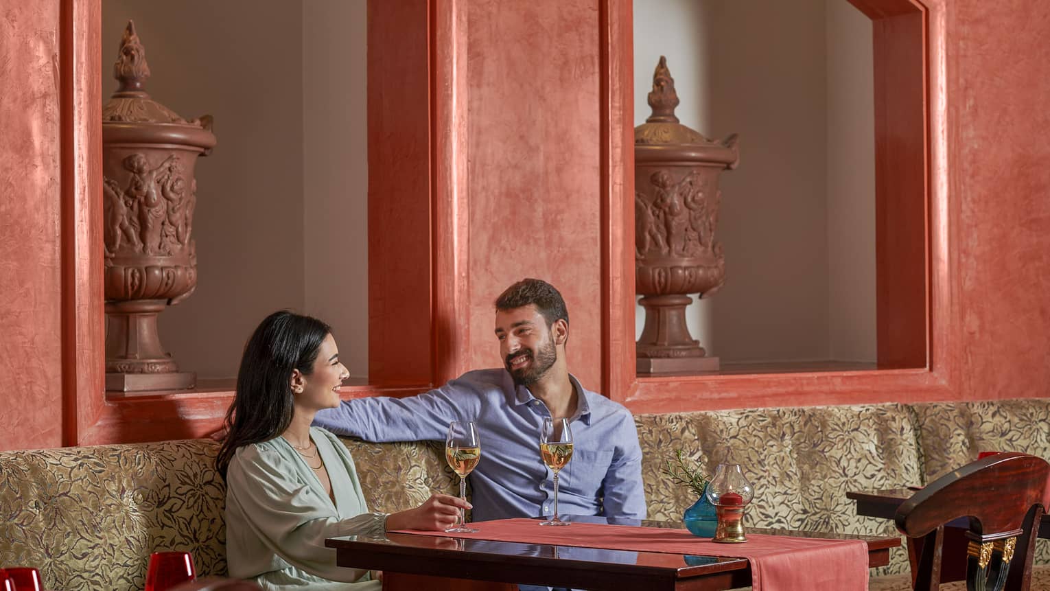 Couple enjoys glass of wine at Stefano's, red accents