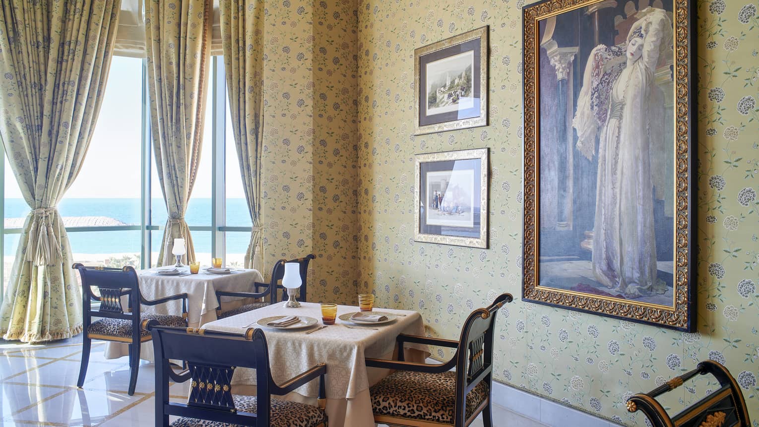 Dining room at Byblos Restaurant with gold curtains and views of the Mediterranean