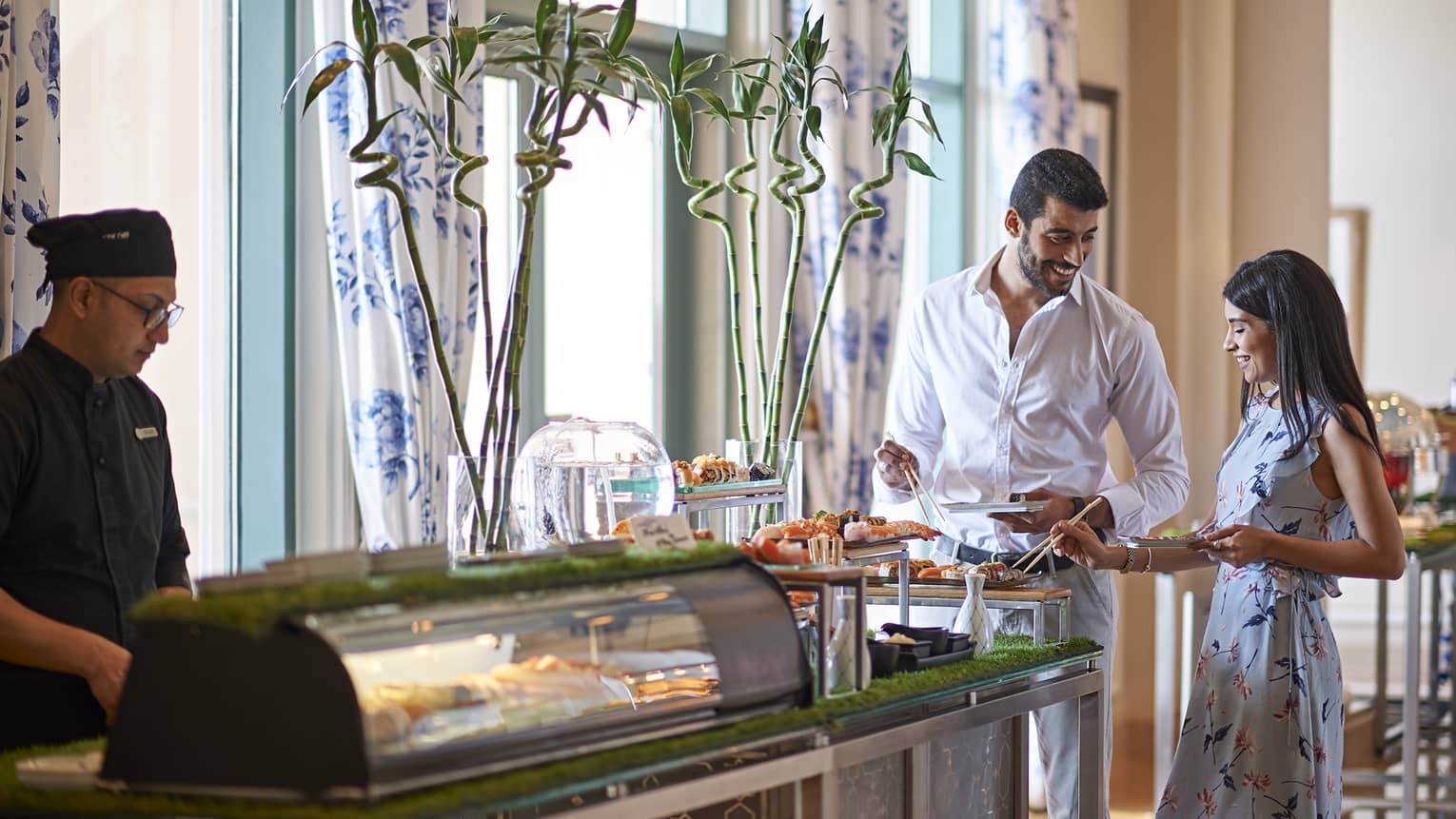 A smiling couple enjoys a brunch buffet at Kala Restaurant