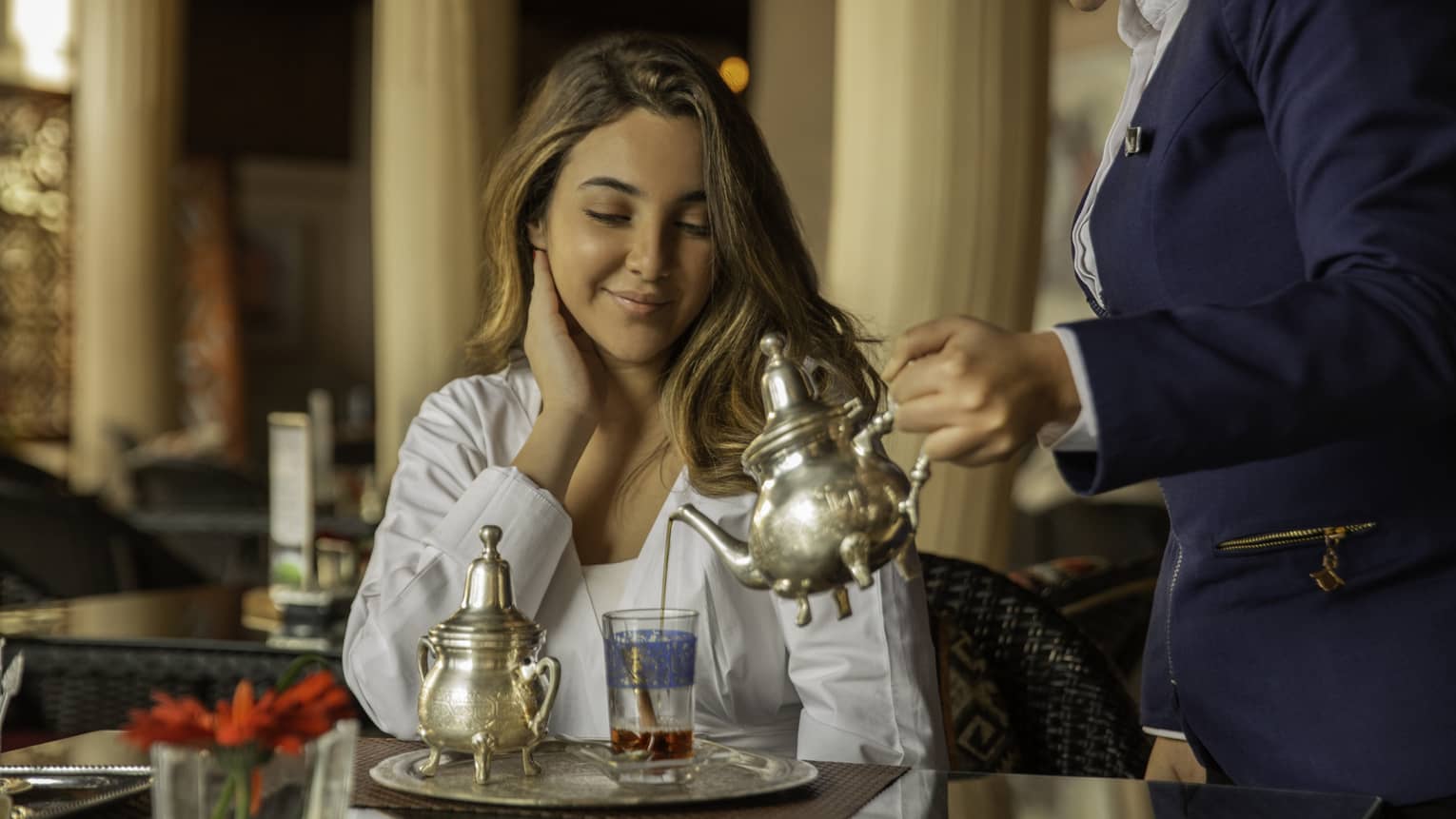 Woman enjoys traditional Moroccan tea at Shisha Lounge
