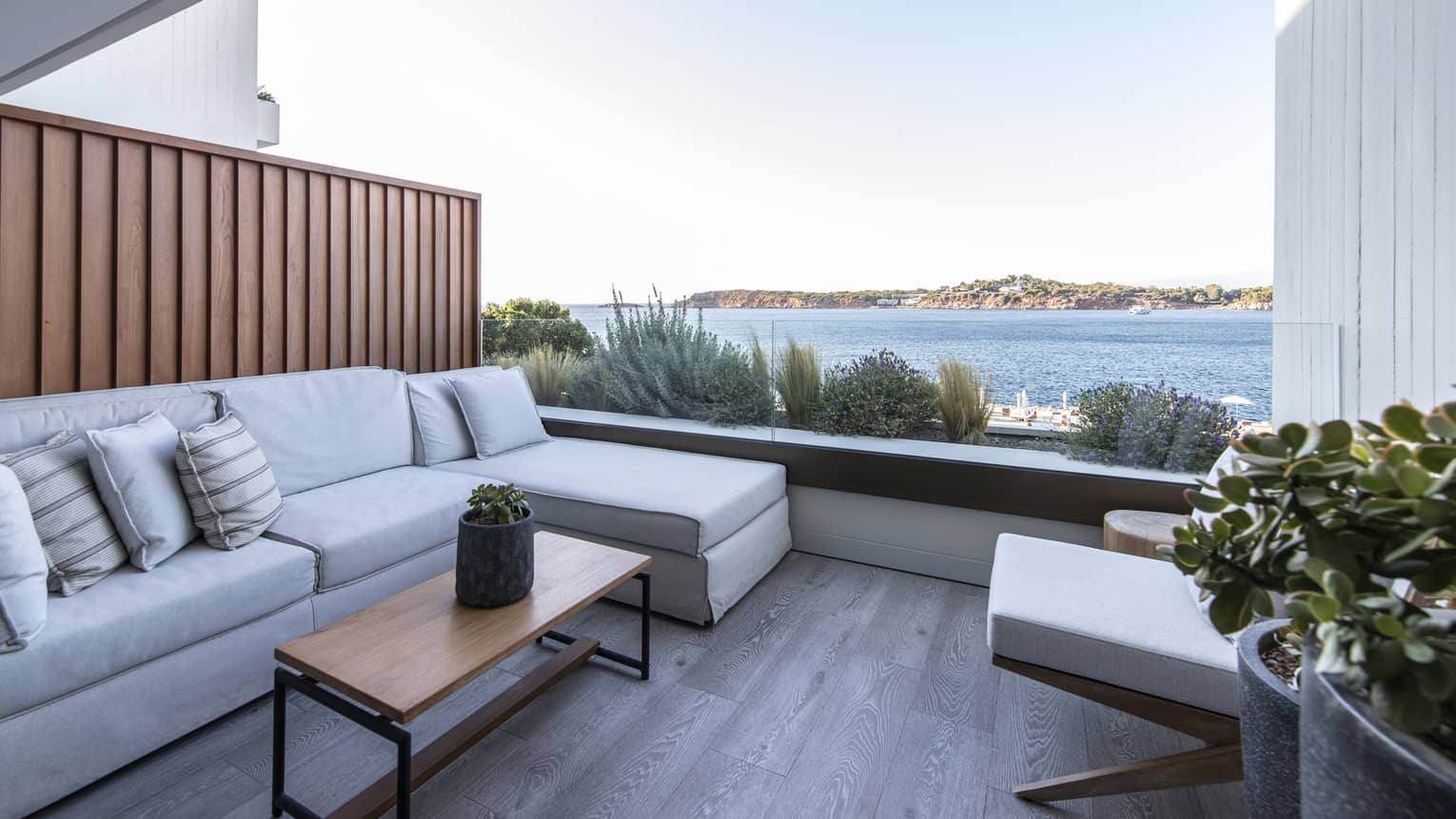 Small terrace with sectional sofa, coffee table sea view
