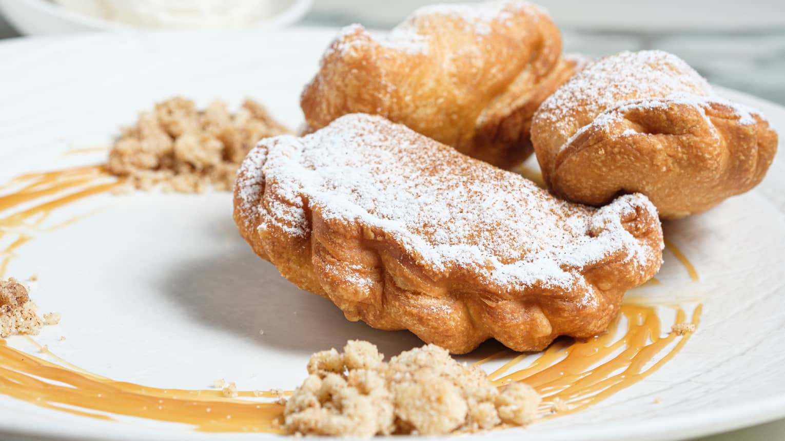 Fried apple pies in a caramel sauce.