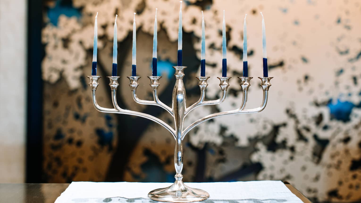 A silver menorah with 9 candles.