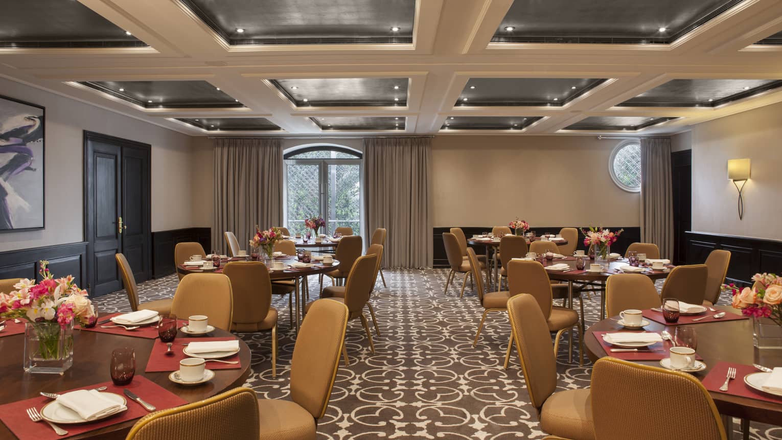Blas Meeting Room round tables with tan chairs, panel ceiling
