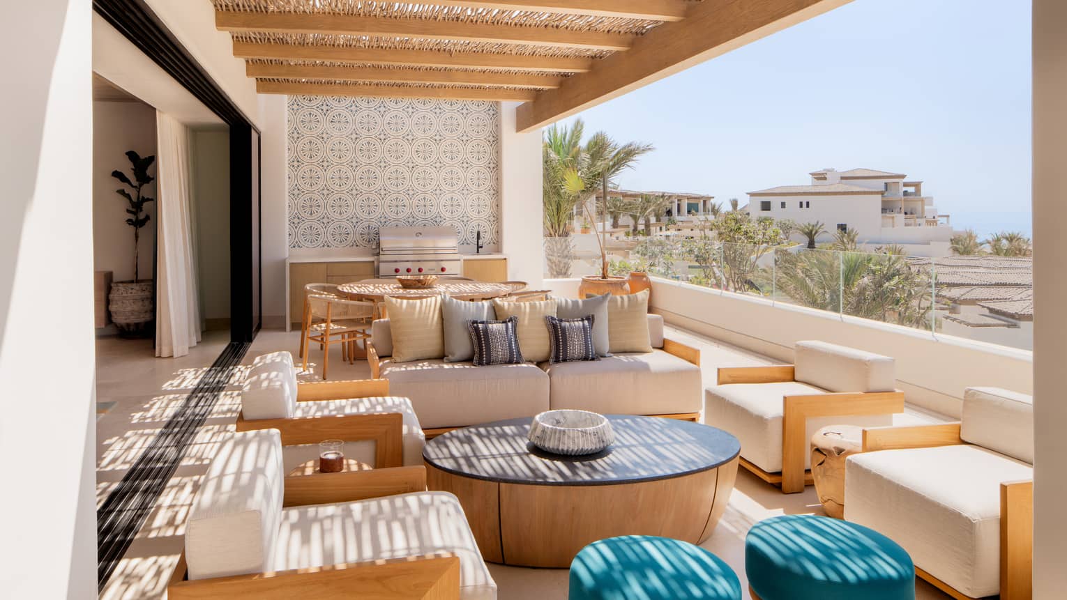 Covered ocean-view terrace of luxury villa, with lots of lounge seating, dining table and grill, at Four Seasons Resort Cabo San Lucas at Cabo Del Sol