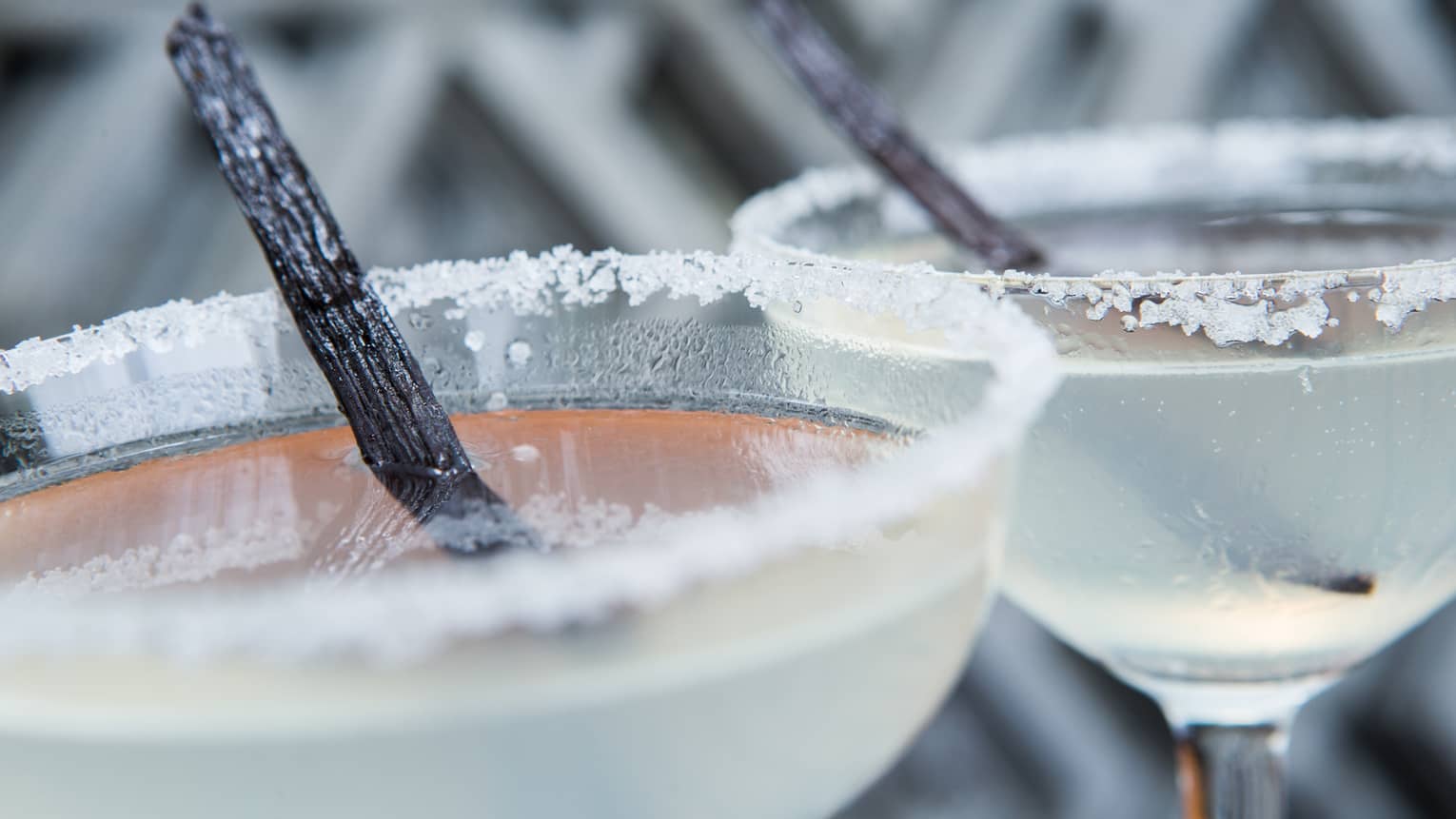Close-up of salt rimmed martini glasses with vanilla pods 