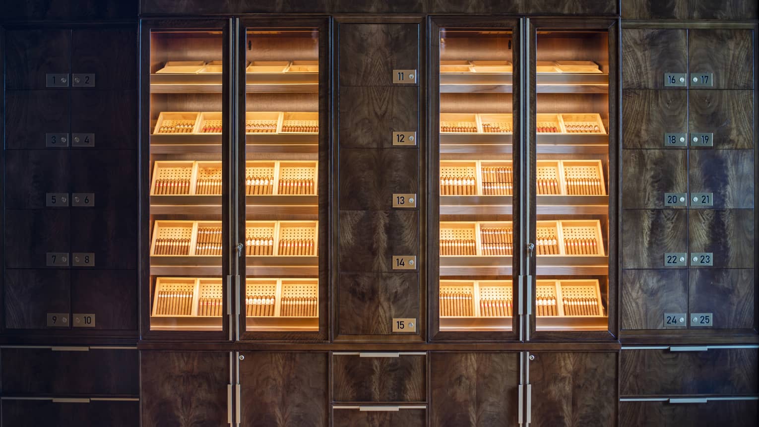 Shelves of cigars behind glass doors.