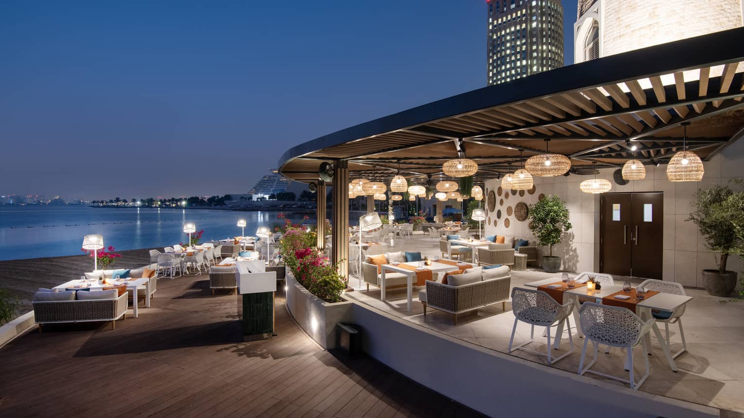 Makani Beach Club terrace overlooking the water at dusk