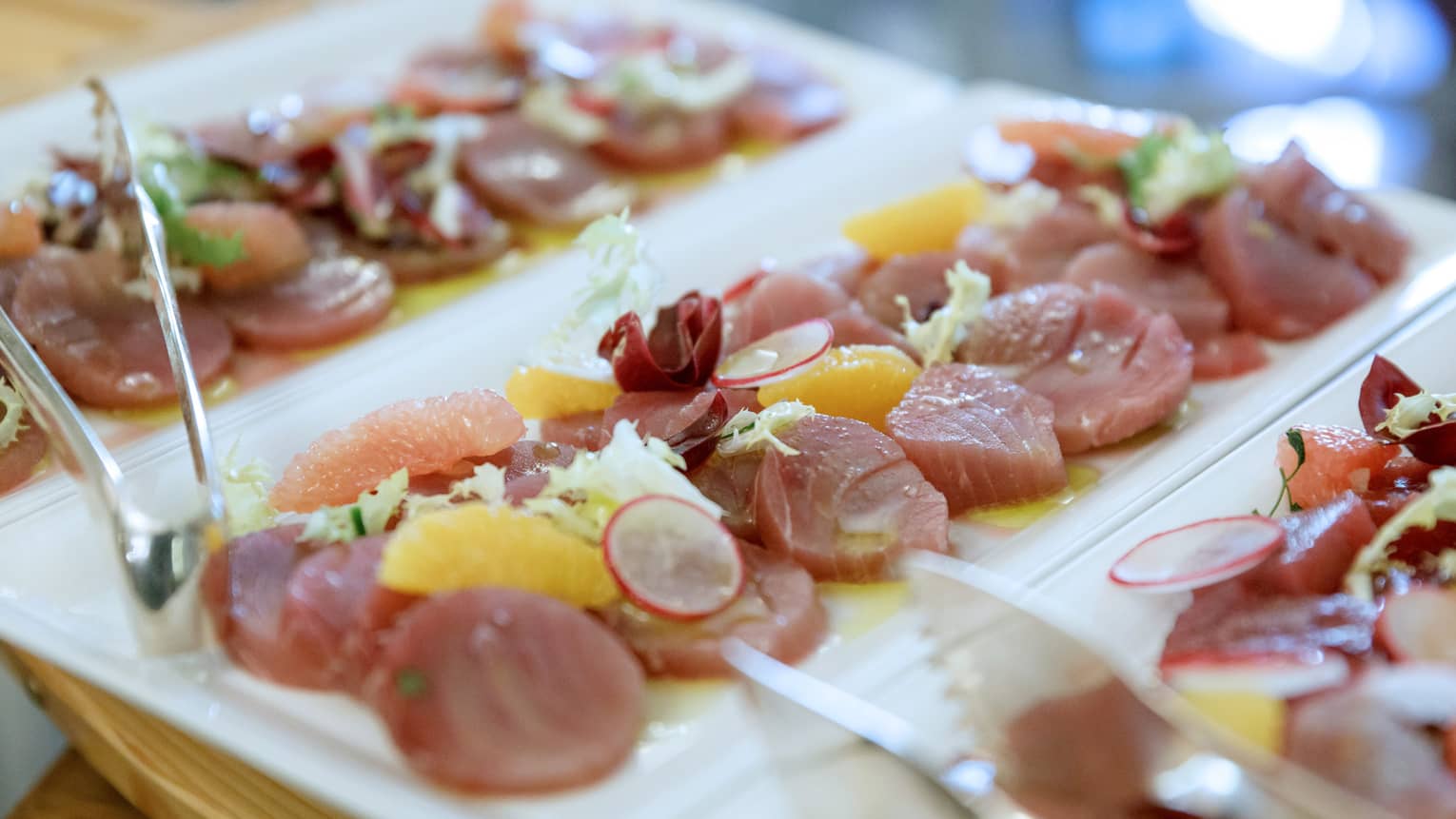 Citrus tuna platter with radish and fruit section garnish